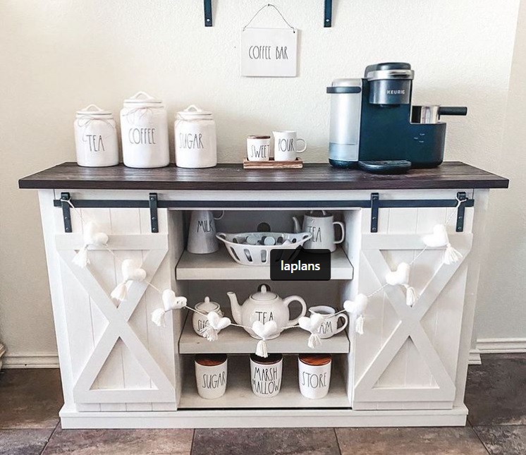 a coffee bar with barn doors sits against a white wall